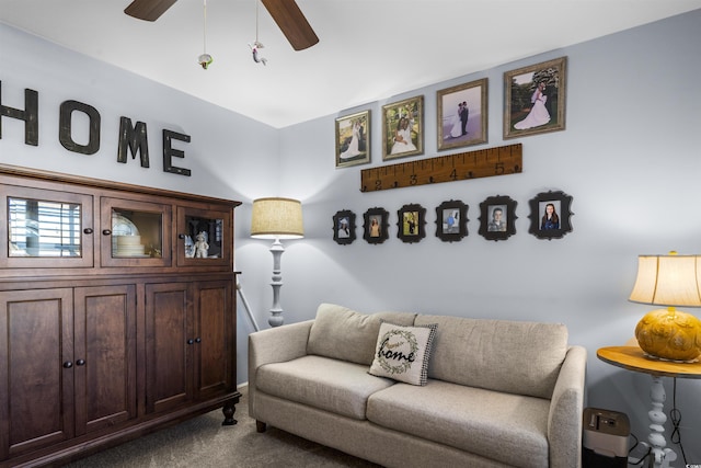 living room with ceiling fan and carpet