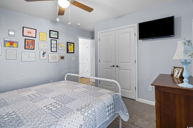 carpeted bedroom featuring ceiling fan and a closet