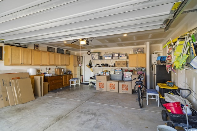 garage featuring stainless steel fridge and a garage door opener