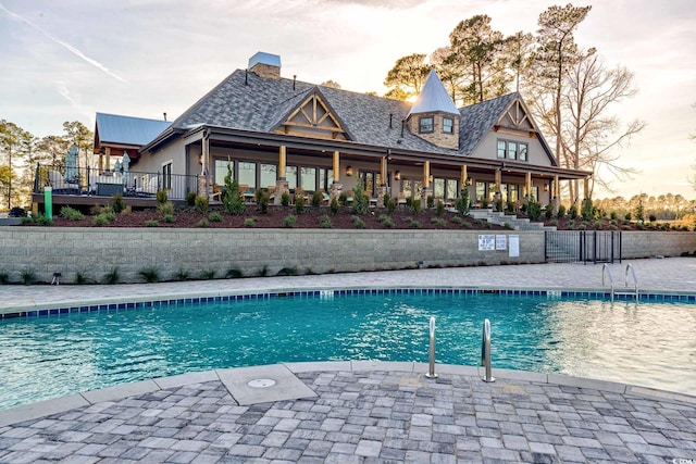 view of pool at dusk