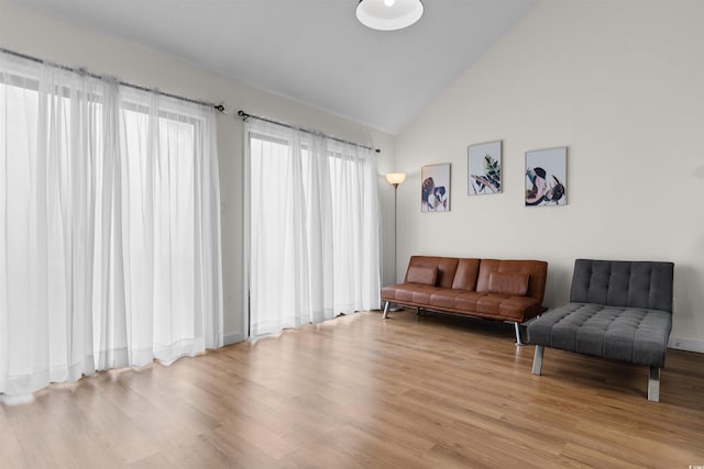 sitting room with vaulted ceiling and light hardwood / wood-style flooring