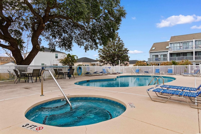 view of pool with a community hot tub and a patio area