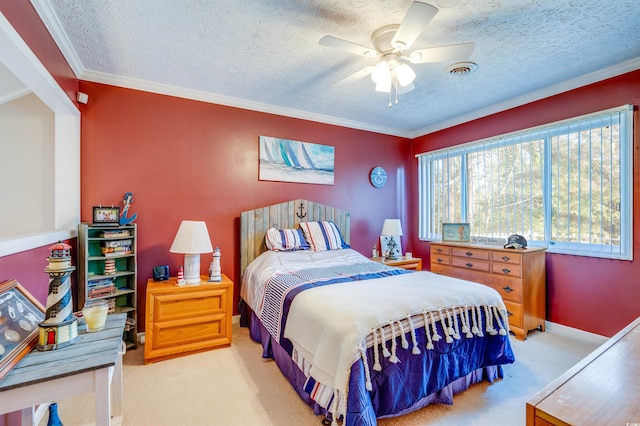 bedroom with light carpet, a textured ceiling, ornamental molding, and ceiling fan