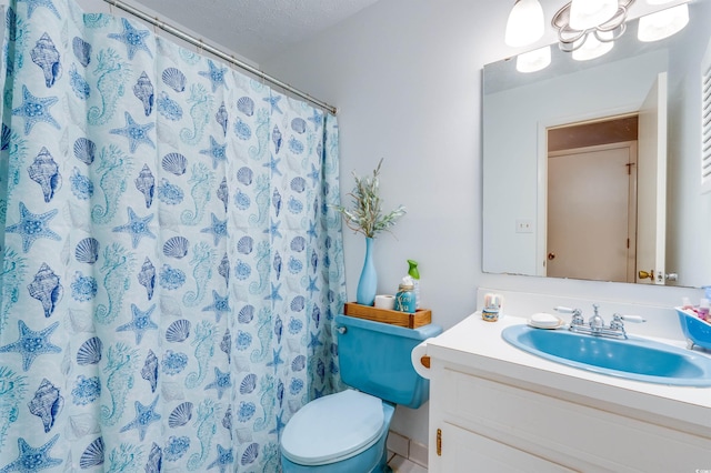 bathroom featuring vanity, curtained shower, a textured ceiling, and toilet