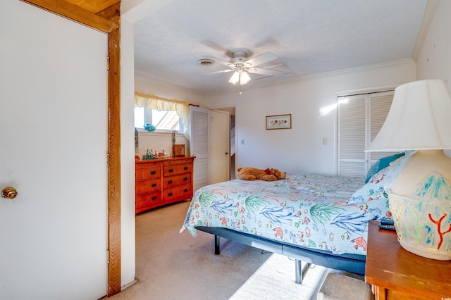 carpeted bedroom featuring a textured ceiling, ornamental molding, a closet, and ceiling fan