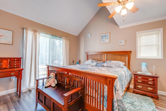 bedroom featuring hardwood / wood-style floors, vaulted ceiling, and ceiling fan