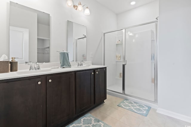 bathroom featuring vanity, tile patterned floors, and a shower with door