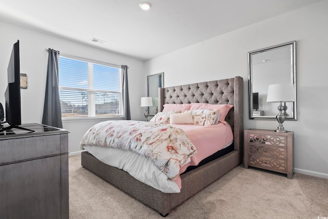 bedroom with light colored carpet