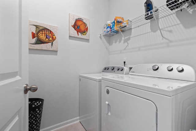 laundry area with separate washer and dryer and light tile patterned flooring