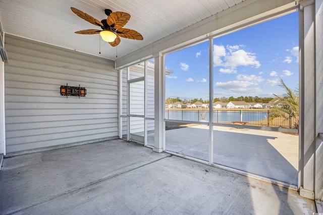 unfurnished sunroom featuring ceiling fan