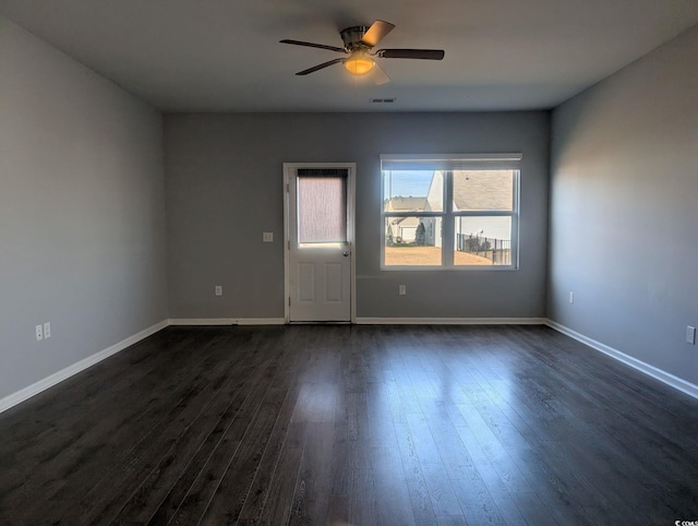 empty room featuring dark wood-type flooring and ceiling fan