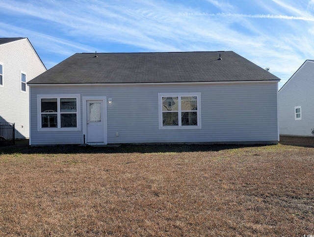 back of property featuring a yard