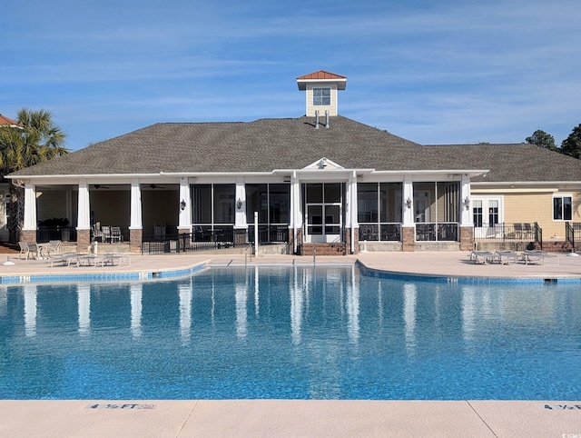 view of swimming pool with a patio area and a sunroom