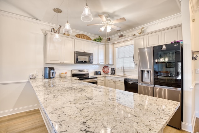 kitchen with kitchen peninsula, decorative backsplash, decorative light fixtures, black appliances, and sink