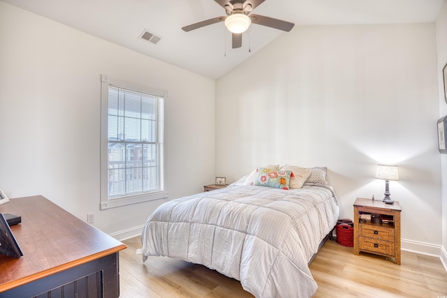 bedroom featuring ceiling fan, hardwood / wood-style floors, and lofted ceiling