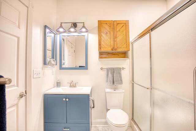 bathroom with toilet, vanity, and an enclosed shower