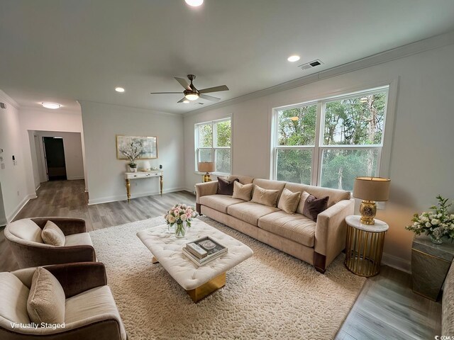 living room with ceiling fan, crown molding, and light hardwood / wood-style flooring