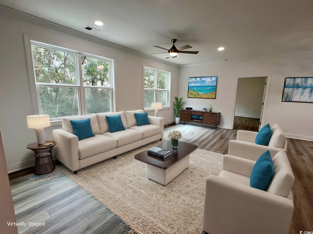 living room with ceiling fan, crown molding, and wood-type flooring