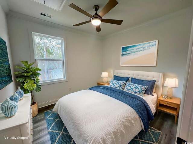 bedroom featuring ceiling fan, dark wood-type flooring, and ornamental molding