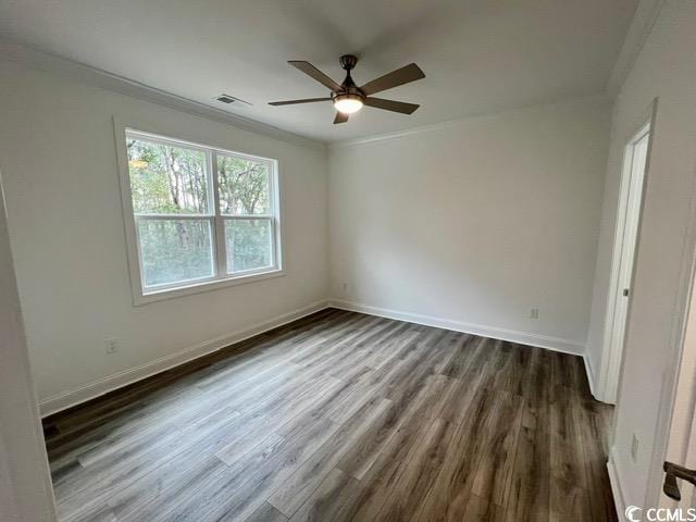 spare room with ceiling fan, dark wood-type flooring, and ornamental molding