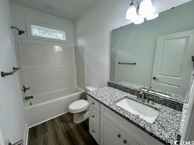 full bathroom featuring wood-type flooring, shower / tub combination, vanity, and toilet