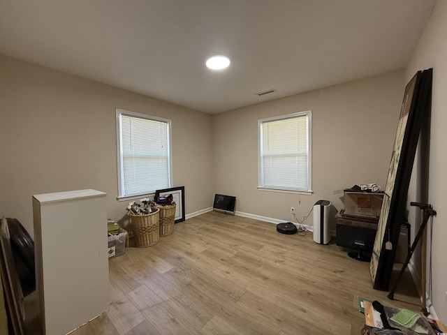 miscellaneous room with visible vents, light wood-style flooring, and baseboards