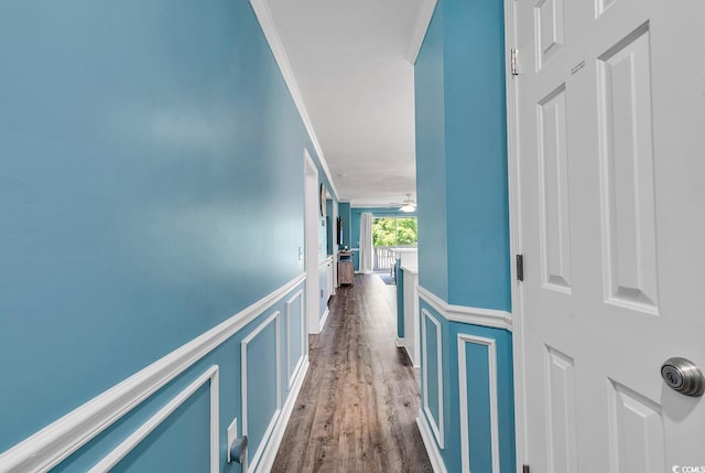 corridor featuring hardwood / wood-style flooring and crown molding