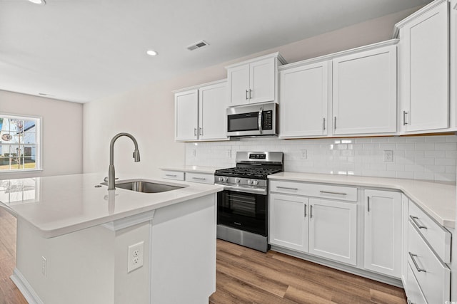 112 Lakota Loop, Longs, SC 29568 - kitchen with appliances with stainless steel finishes, a sink, light wood finished floors, tasteful backsplash, and recessed lighting