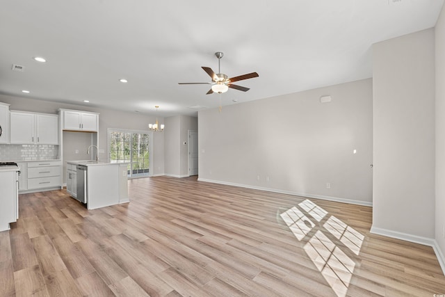 112 Lakota Loop, Longs, SC 29568 - unfurnished living room with a sink, ceiling fan, a chandelier, light wood-type flooring, and baseboards