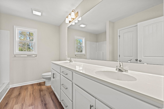 112 Lakota Loop, Longs, SC 29568 - bathroom featuring double vanity, baseboards, toilet, wood finished floors, and a shower
