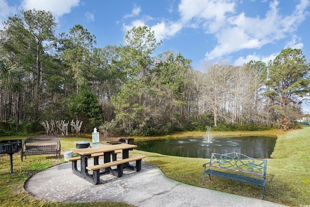 view of home's community with a yard and a water view