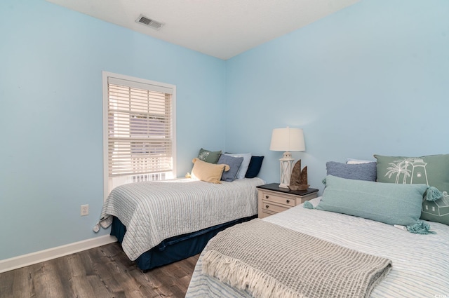 bedroom featuring dark wood-type flooring