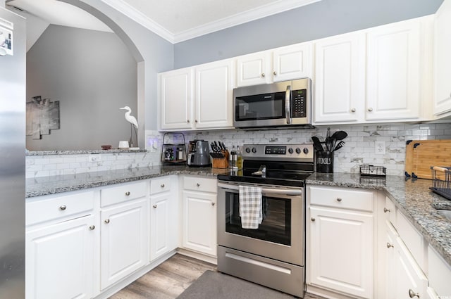 kitchen featuring white cabinets, appliances with stainless steel finishes, and stone counters