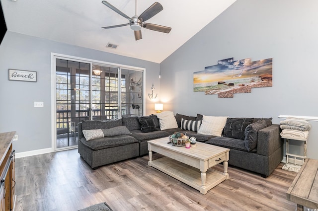 living room featuring ceiling fan, hardwood / wood-style flooring, and high vaulted ceiling