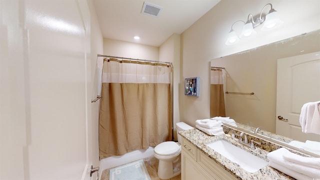 full bathroom with vanity, toilet, and shower / tub combo with curtain