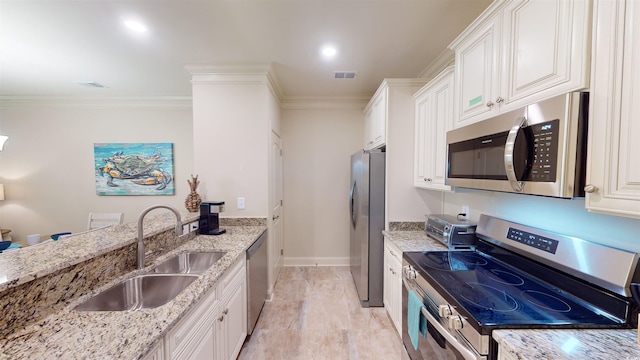 kitchen featuring light stone counters, sink, stainless steel appliances, and white cabinets