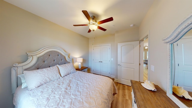 bedroom featuring wood-type flooring, a closet, and ceiling fan