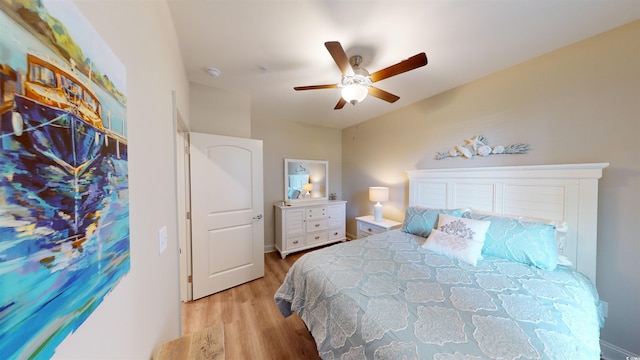 bedroom with ceiling fan and light hardwood / wood-style flooring