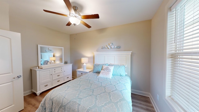 bedroom with dark hardwood / wood-style floors and ceiling fan