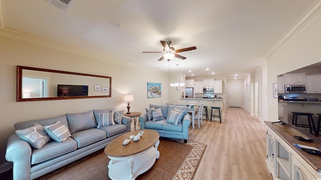 living room featuring crown molding, light hardwood / wood-style flooring, and ceiling fan with notable chandelier