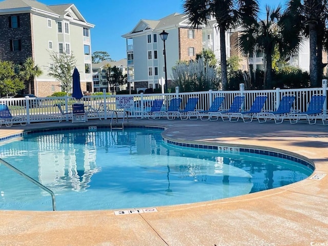 view of swimming pool featuring a patio area