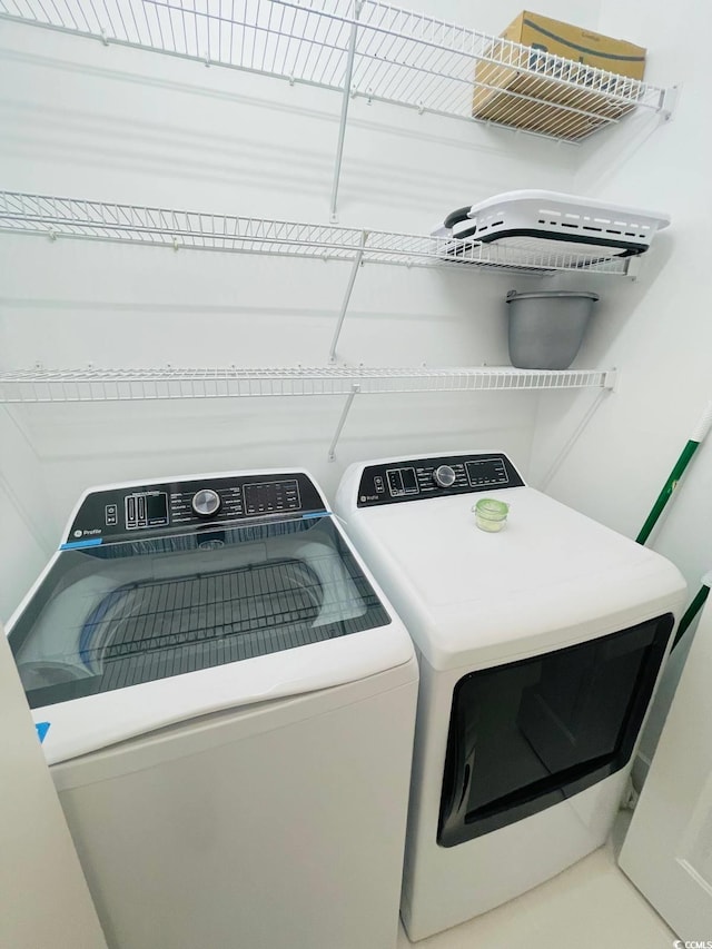 washroom featuring washing machine and dryer