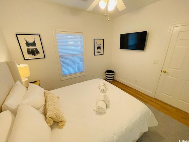 bedroom with ceiling fan and hardwood / wood-style floors