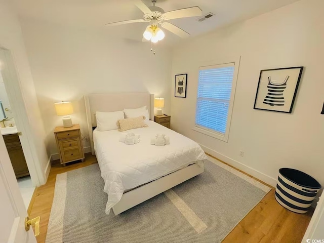 bedroom with ceiling fan and light hardwood / wood-style flooring