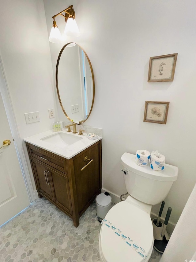 bathroom featuring toilet and vanity