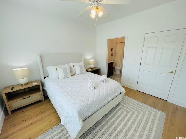 bedroom with ceiling fan, wood-type flooring, and connected bathroom