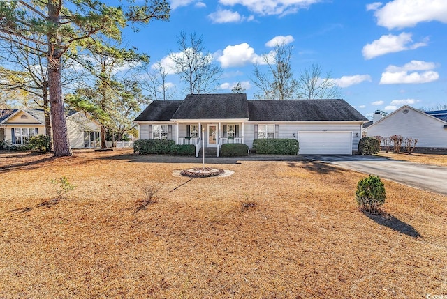 single story home with a garage and covered porch