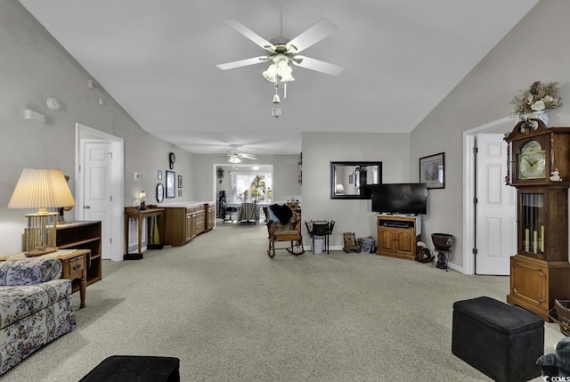 carpeted living room featuring vaulted ceiling and ceiling fan