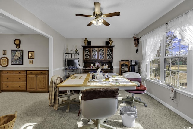 carpeted dining area featuring ceiling fan