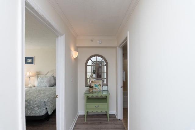 hall featuring crown molding and dark hardwood / wood-style flooring